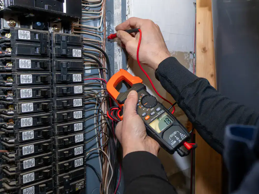 Electrician testing a residential electrical panel in Dallas County, Texas, ensuring circuits and breakers are functioning safely